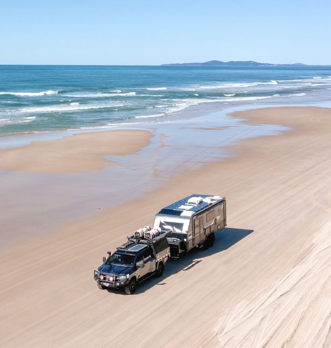 4WD Towing Caravan on beach 