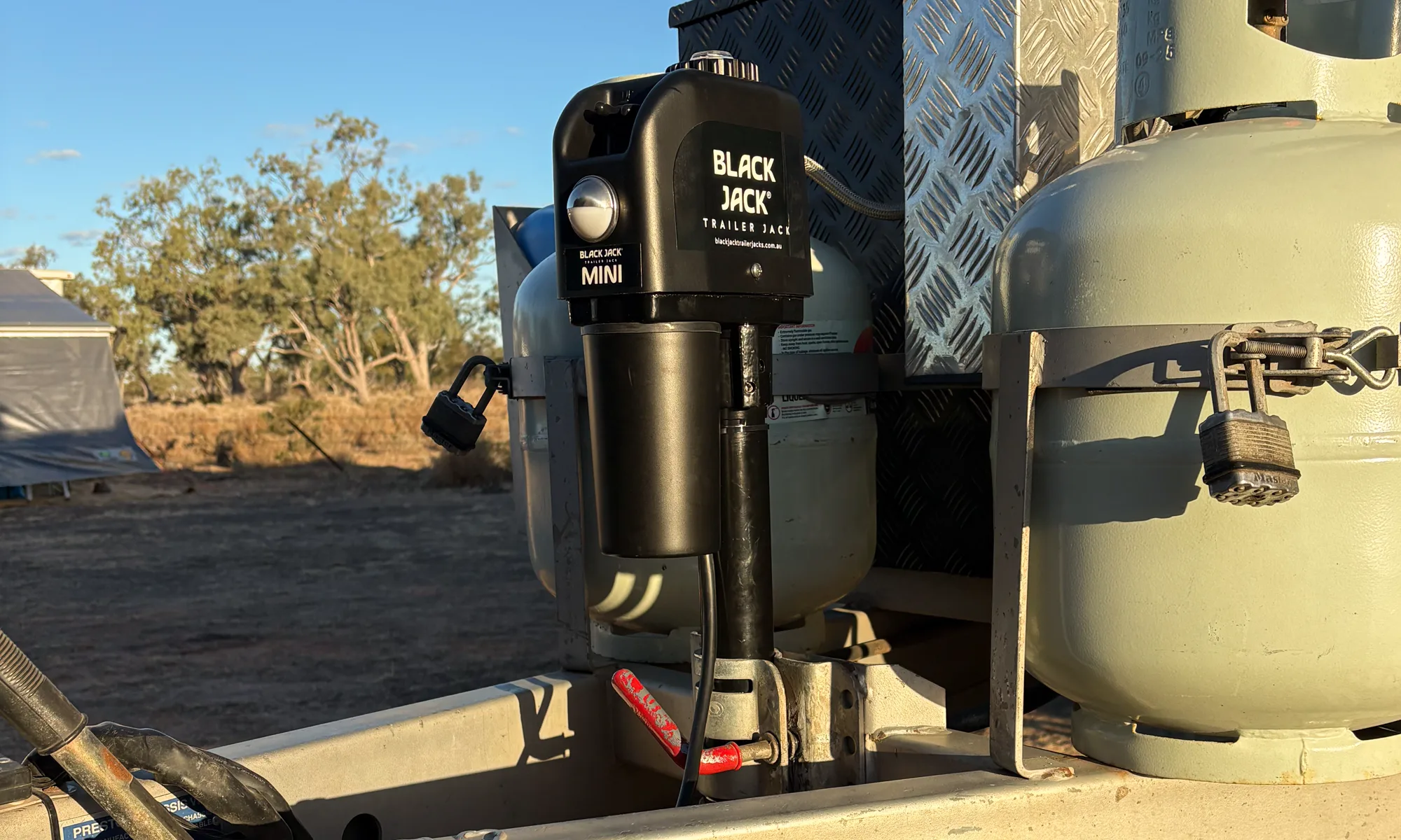 The Black Jack Mini electric jockey wheel fitted to the caravan drawbar between the gas bottles